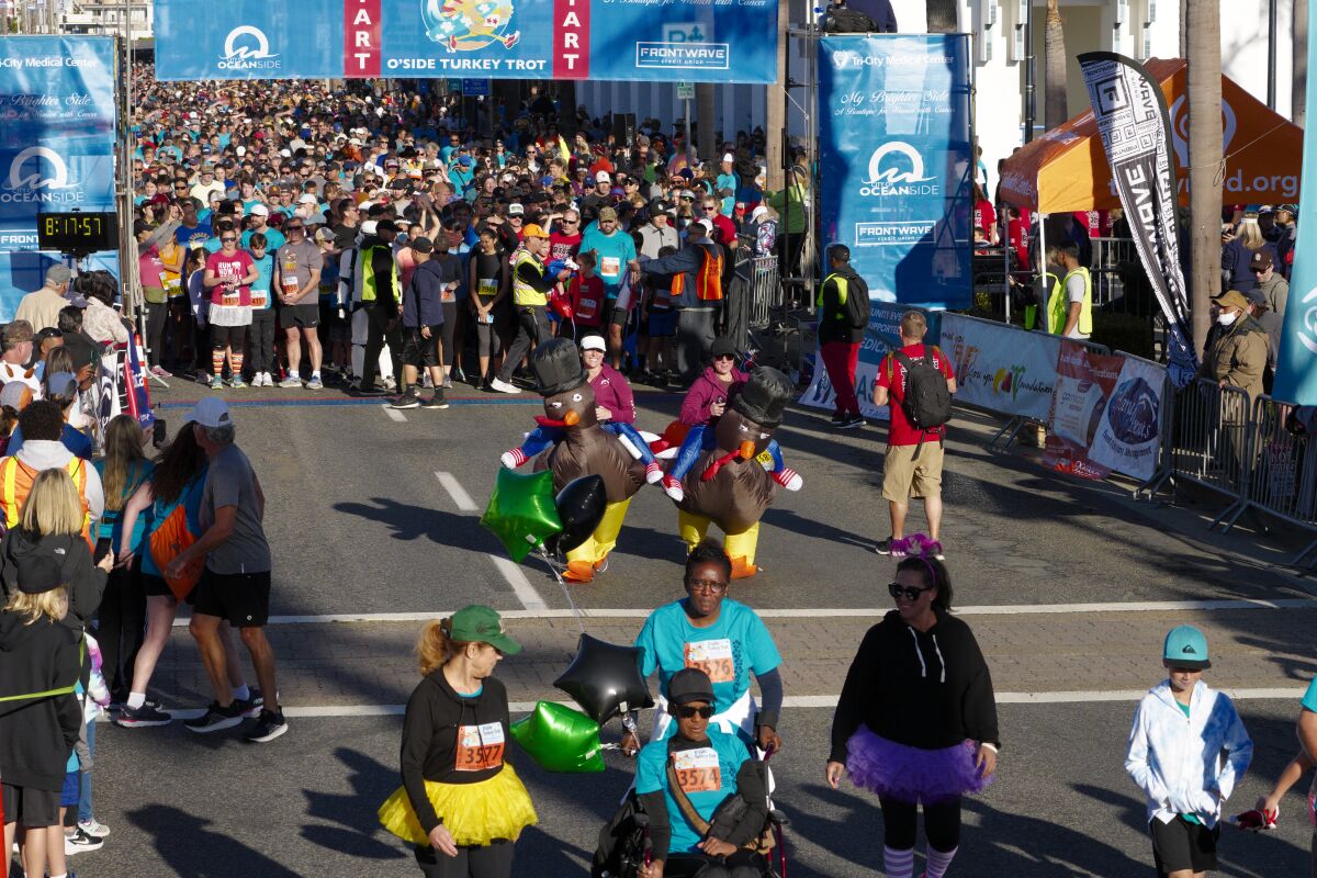 Runners in turkey costumes, tutus and regular runners gear start the 16th Annual Oceanside Turkey Trot Thursday