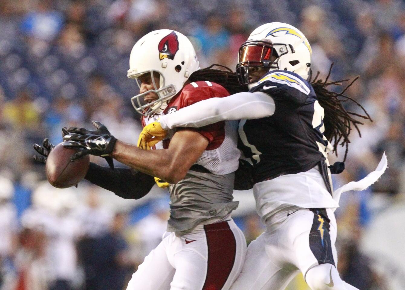 The Chargers' Jahleel Addae, right, breaks up a pass intended for the Cardinals' Larry Fitzgerald.