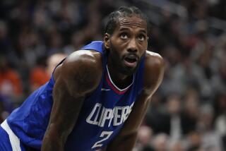 Los Angeles Clippers forward Kawhi Leonard pauses during the second half of an NBA basketball game.