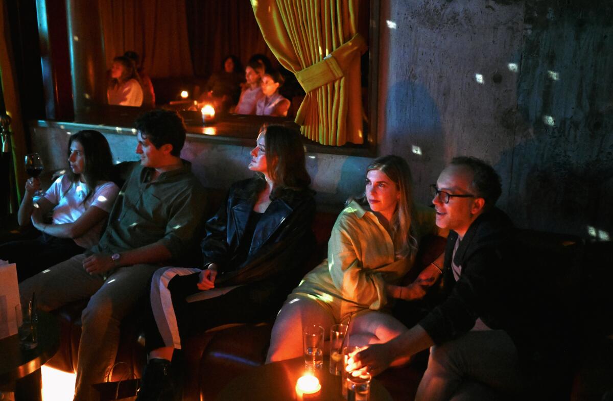 Guests enjoy music by John Mayer during a Record Club event at Grandmaster Recorders in Los Angeles.