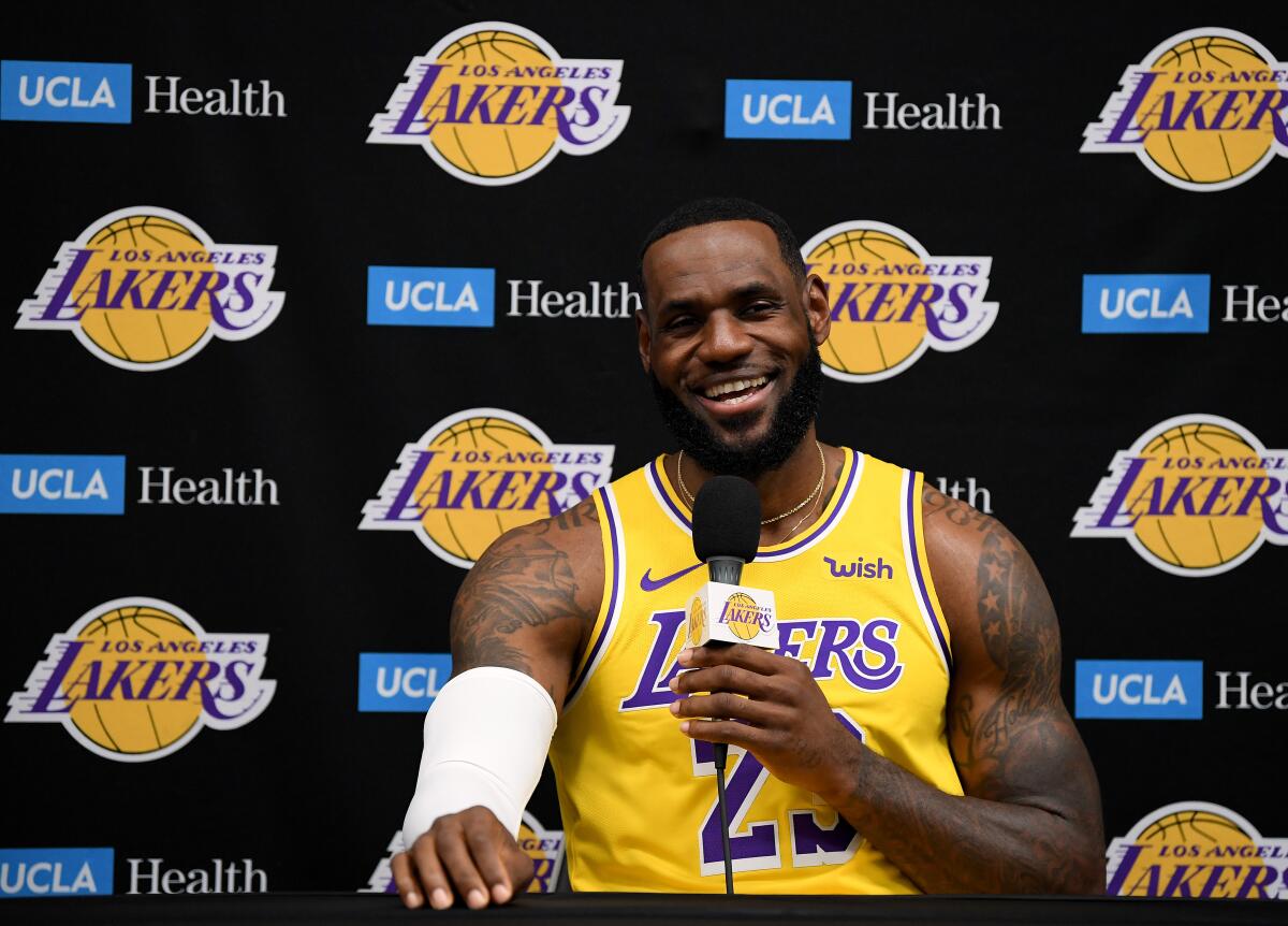 LeBron James smiles while speaking to reporters during Lakers media day in El Segundo on Friday.