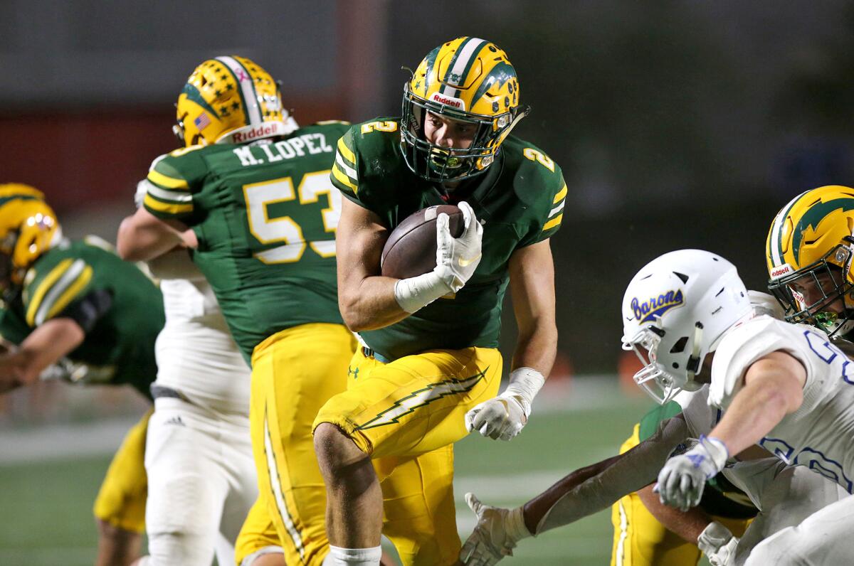 Edison's Mike Walters (2) runs behind blocker Mateo Lopez (53) for a touchdown in a Sunset League game against Fountain Valley at Orange Coast College on Friday.