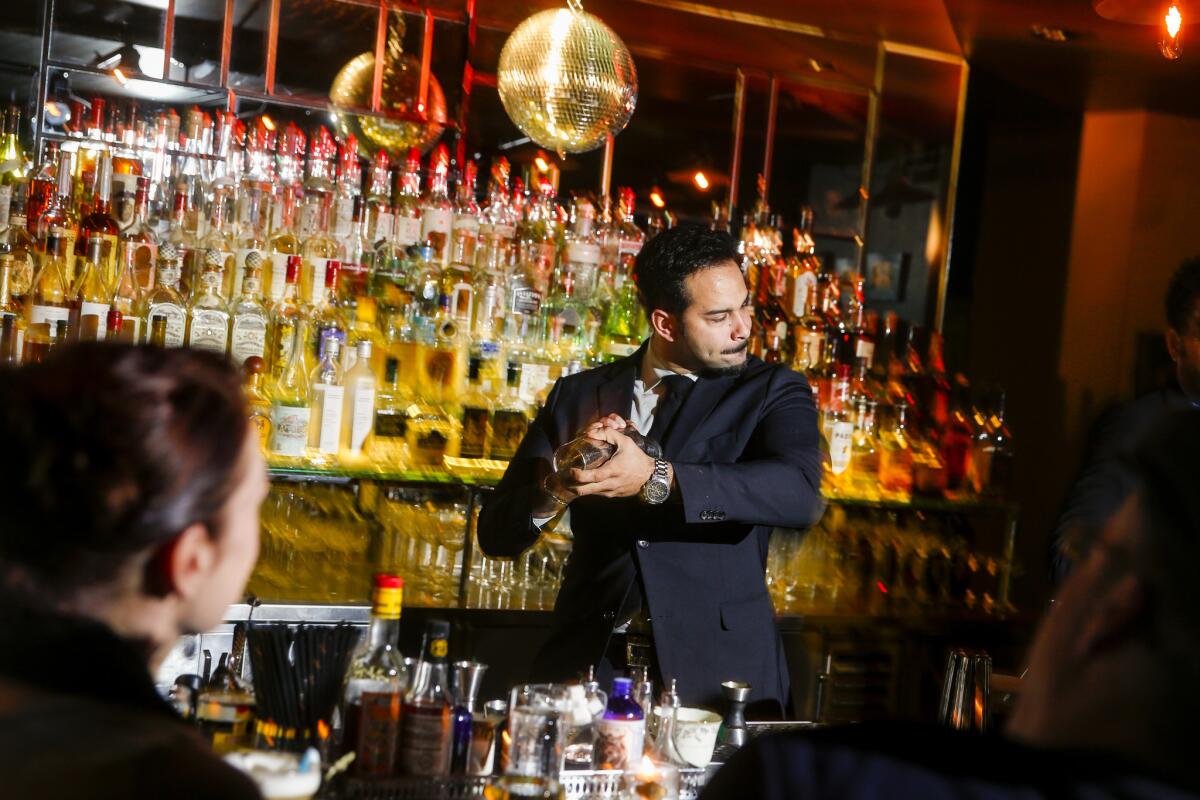 At the Fiscal Agent bar and lounge above Barrel and Ashes on Ventura Boulevard in Studio City, executive beverage director Julian Cox mixes a drink.