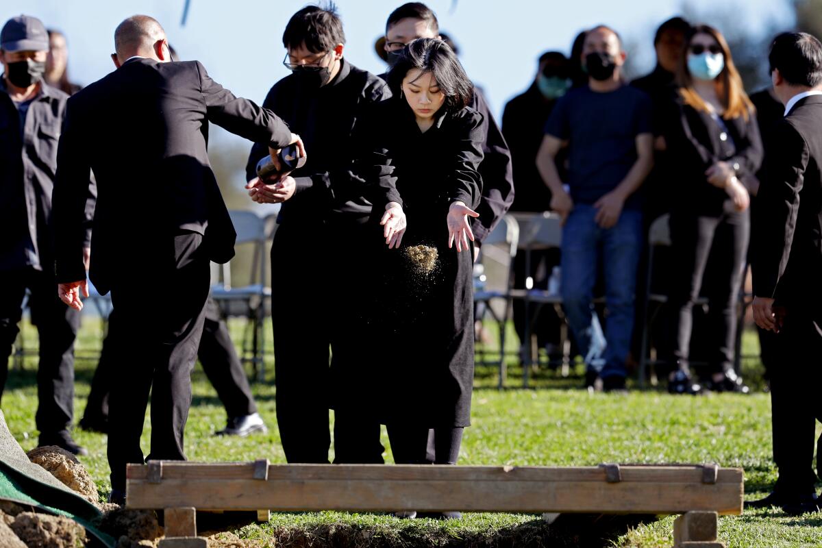 Kathleen Fong pays respect to her aunt, Xiujuan Yu, during her funeral service at Rose Hills Memorial Park