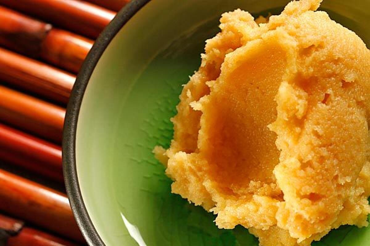 A traditional artisan grows mold to create miso.