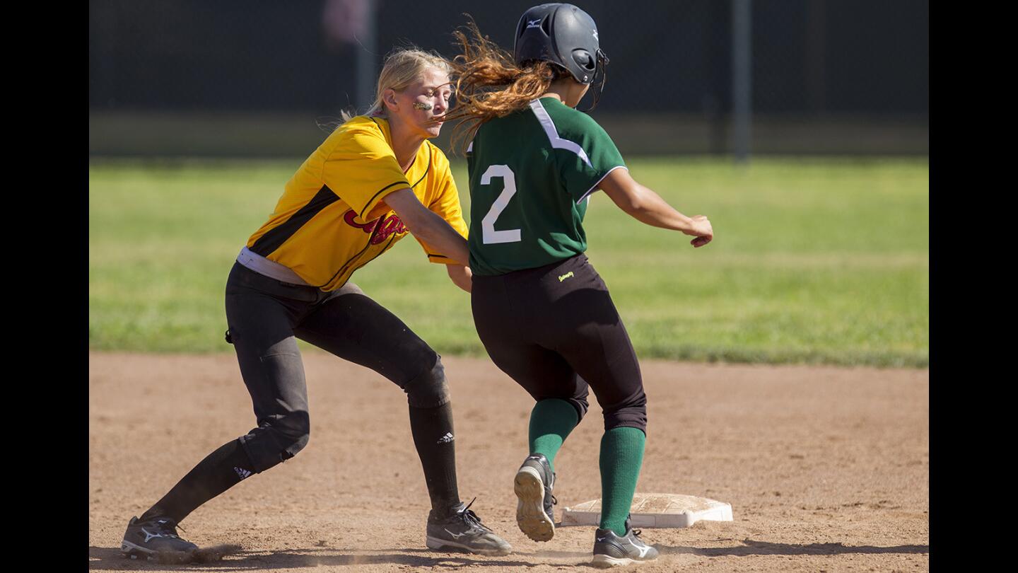 Estancia's Emily Kubisty tags out Costa Mesa's Saira Gomez on a stolen base attempt during an Orange Coast League game at Estancia High School on Thursday, April 21.