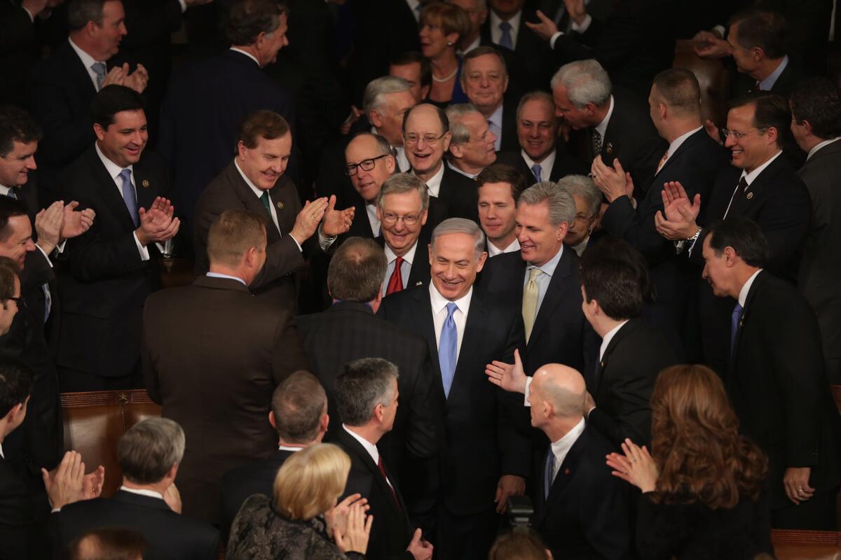 Israeli Prime Minister Benjamin Netanyahu, center, is greeted by members of Congress as he arrives to deliver a speech about nuclear talks with Iran.
