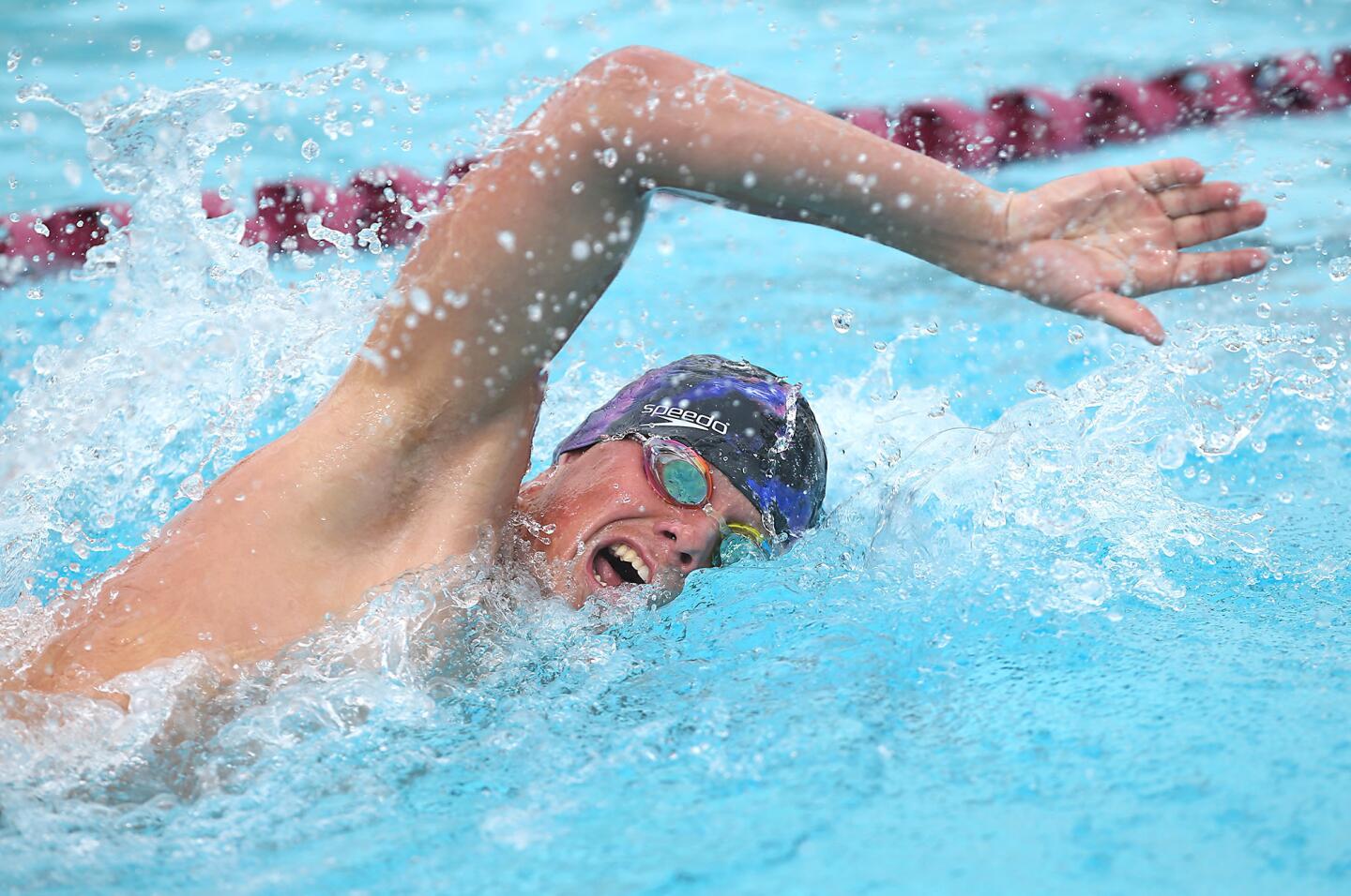 Costa Mesa's Augie Cunningham stretches for the finish line in the boys varsity 500 meter swim.