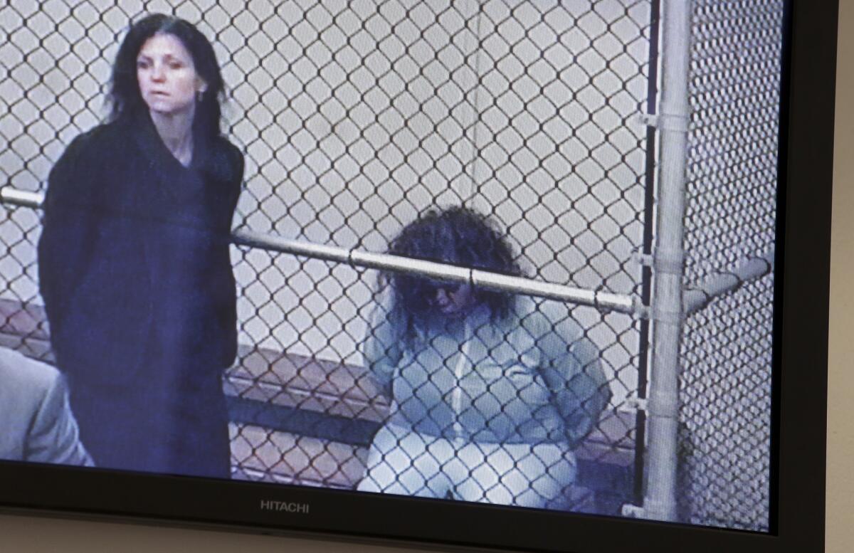 Marilyn Kay Edge, right, is shown on a monitor during a video arraignment with Orange County public defender Arlene Speiser.