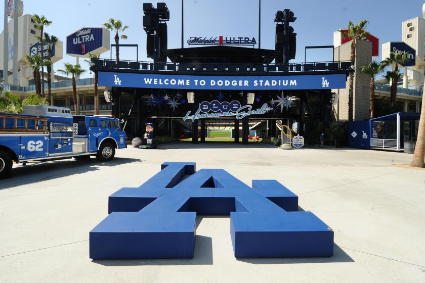 Dodger displays sit beyond the center field bleachers as the Dodgers prepare for opening day 2021 at Dodger Stadium.