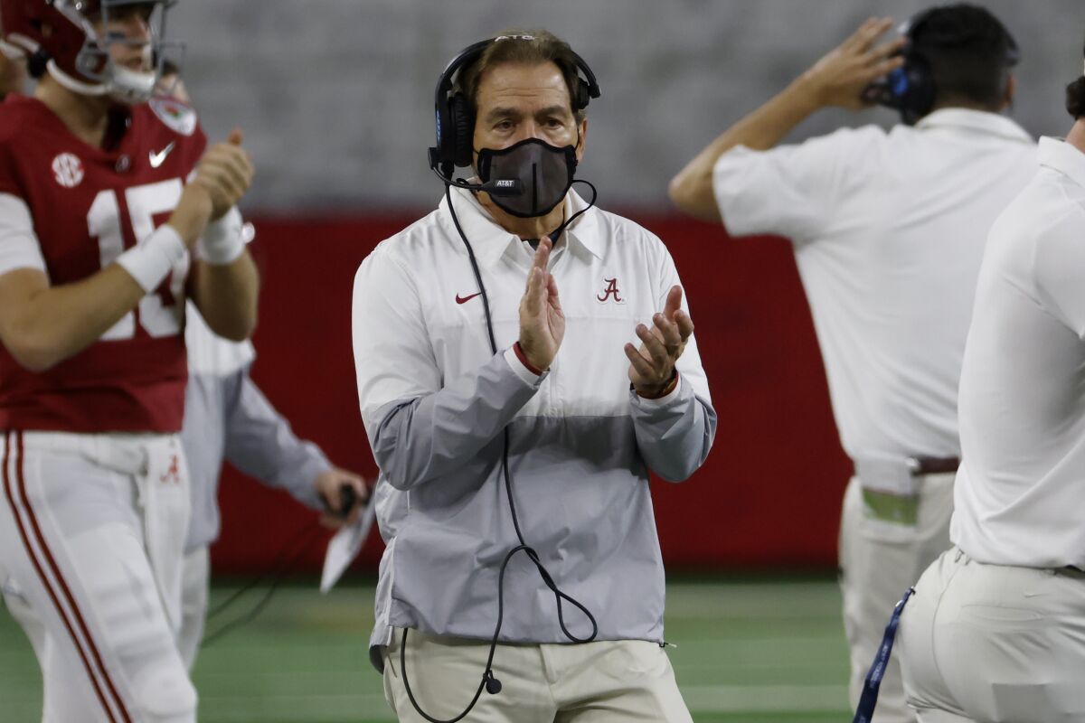 Alabama head coach Nick Saban applauds as he watches his team play Notre Dame late in the second half of the Rose Bowl NCAA college football game in Arlington, Texas, Friday, Jan. 1, 2021. (AP Photo/Ron Jenkins)