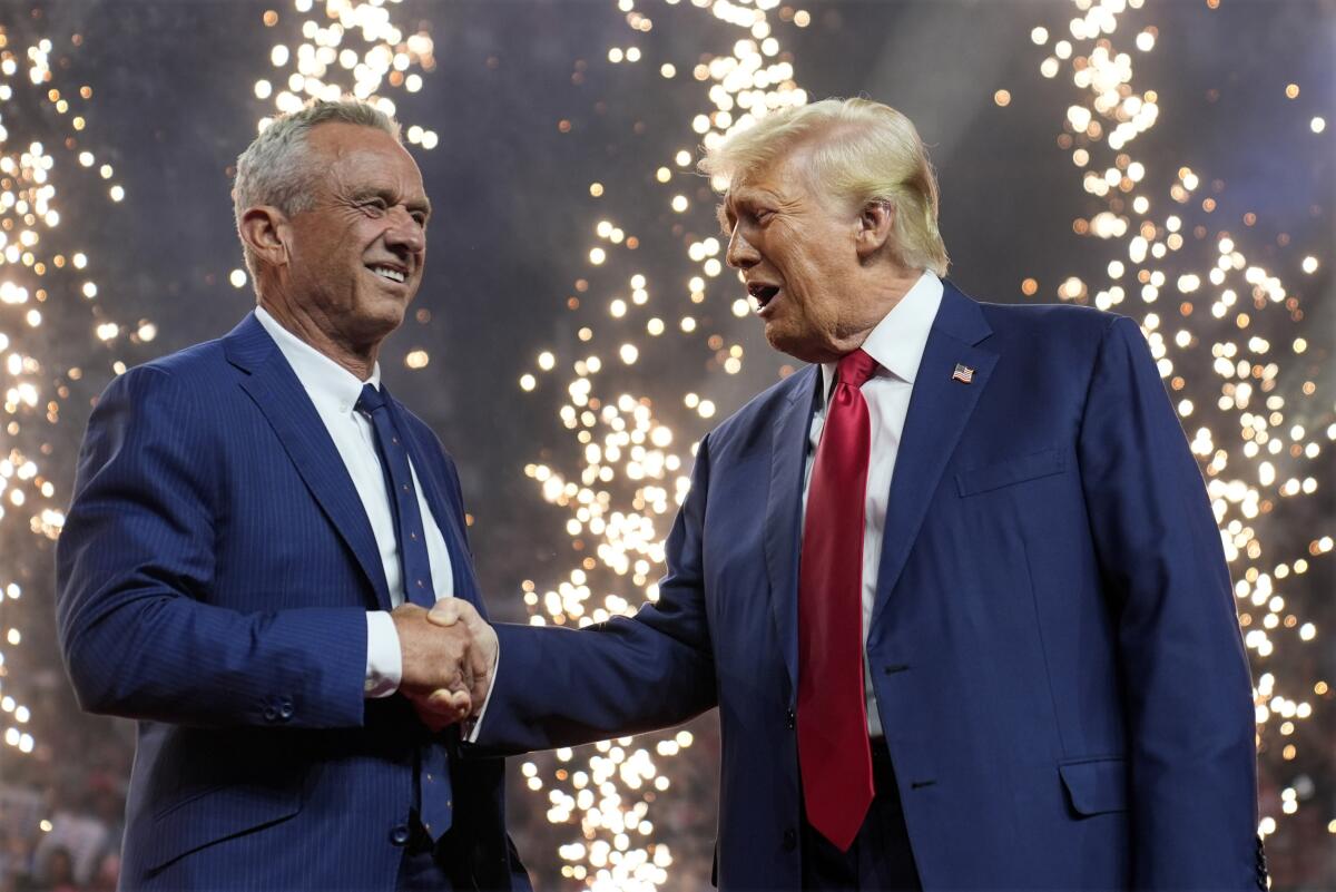 Robert F. Kennedy Jr. and Donald Trump shake hands at a campaign rally in Arizona last week.