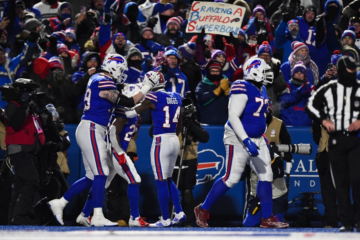 Buffalo Bills running back Devin Singletary, second from left, celebrates his touchdown with his teammates during the first half of an NFL wild-card playoff football game against the New England Patriots, Saturday, Jan. 15, 2022, in Orchard Park, N.Y. (AP Photo/Adrian Kraus)