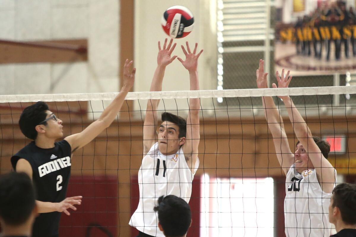 Ocean View High's Christopher Haase (11) gets a piece of a ball hit by Godinez's Cesar Mascareno (2) in a Golden West League match on Thursday.