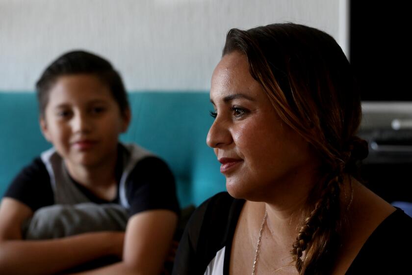 APACIO EL GRANDE, GUANAJUATO - AUGUST 21: Monica Cardenas, 36, shown with son Carlos Maldonado, 11, left, along with her husband and two other other children, not shown, live in the Fuentes de Balvanera housing community on Friday, Aug. 21, 2020 in Apacio el Grande, Guanajuato. Cardenas was laid off June 22nd of this year from her job of over five years at Aernnova, in Queretaro. Monica assembled parts for helicopters and airplanes. She made roughly $114 US dollars a week. The growth of the Mexican middle class was a NAFTA success story. Now, with half a million businesses expected to close this year because of COVID-19 and an economic recession that is predicted to take a decade to heal, many people are slipping back into poverty. (Gary Coronado / Los Angeles Times)