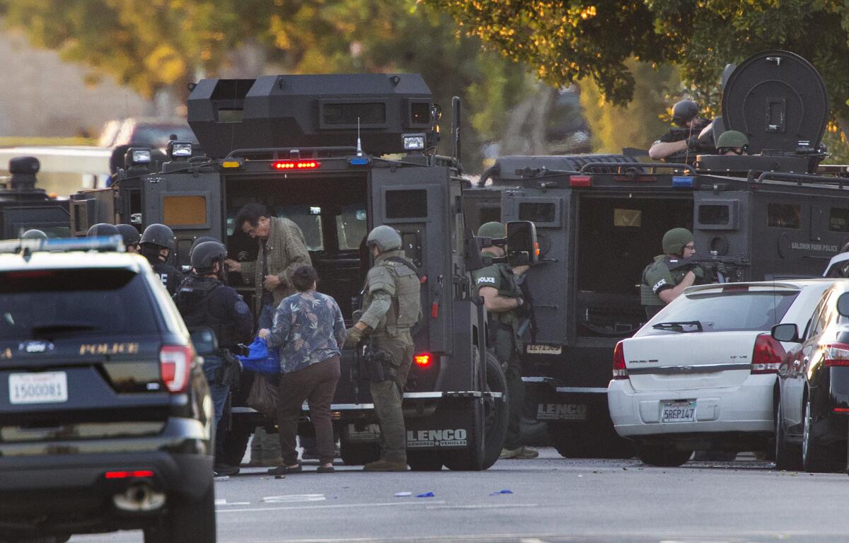 SWAT officers evacuate neighbors as they respond to a shooting in Azusa.