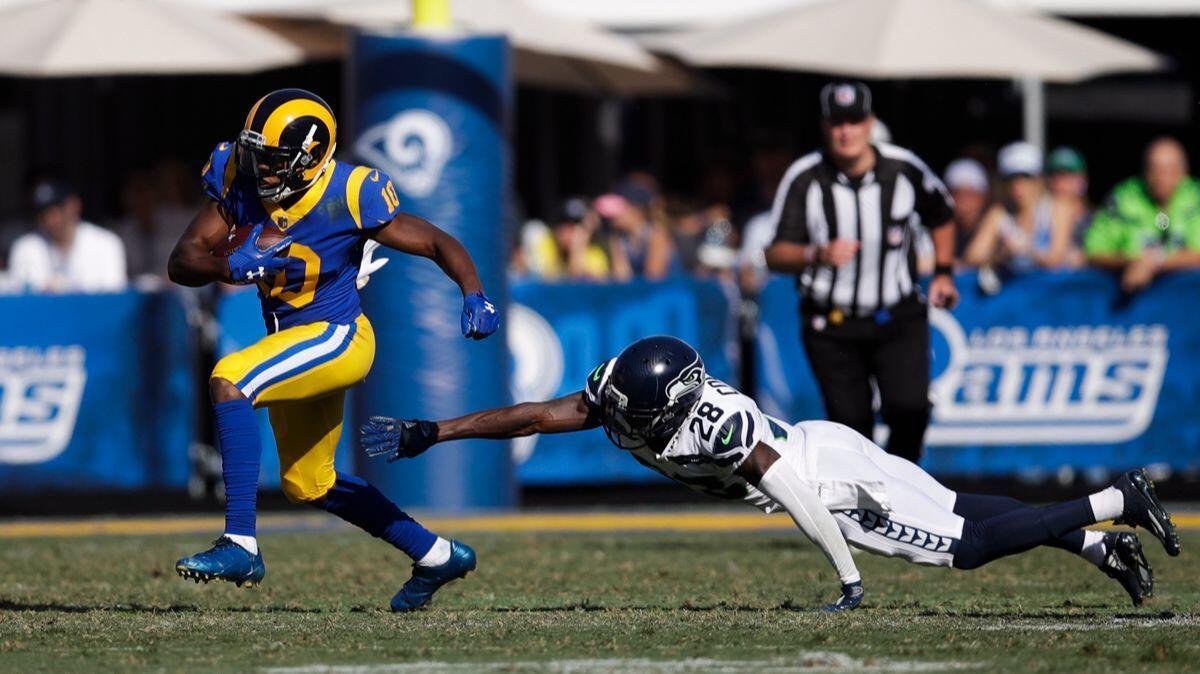 Rams' Pharoh Cooper, left, carries the ball past Seattle Seahawks' Justin Coleman during a game on Sunday.