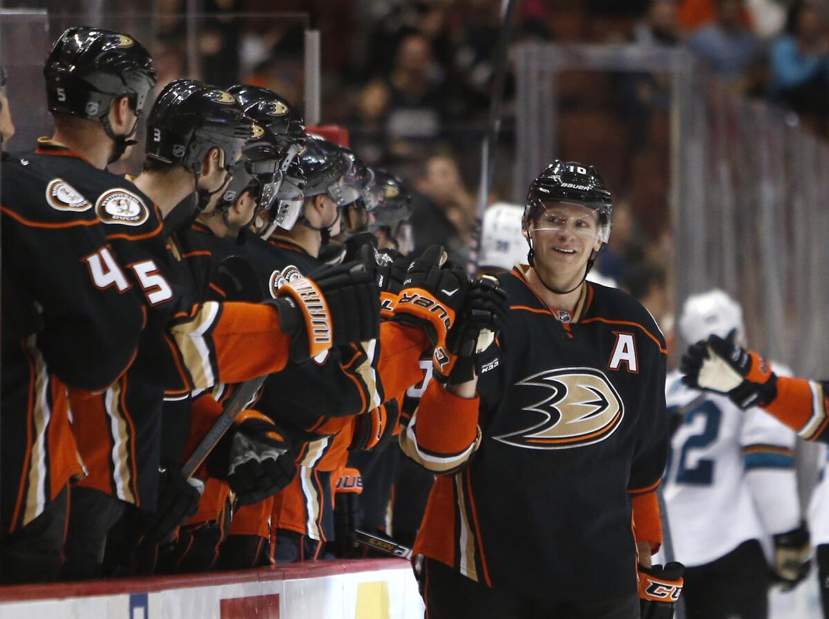 Corey Perry gets congratulations from his Ducks teammates after scoring against the San Jose Sharks on Saturday.