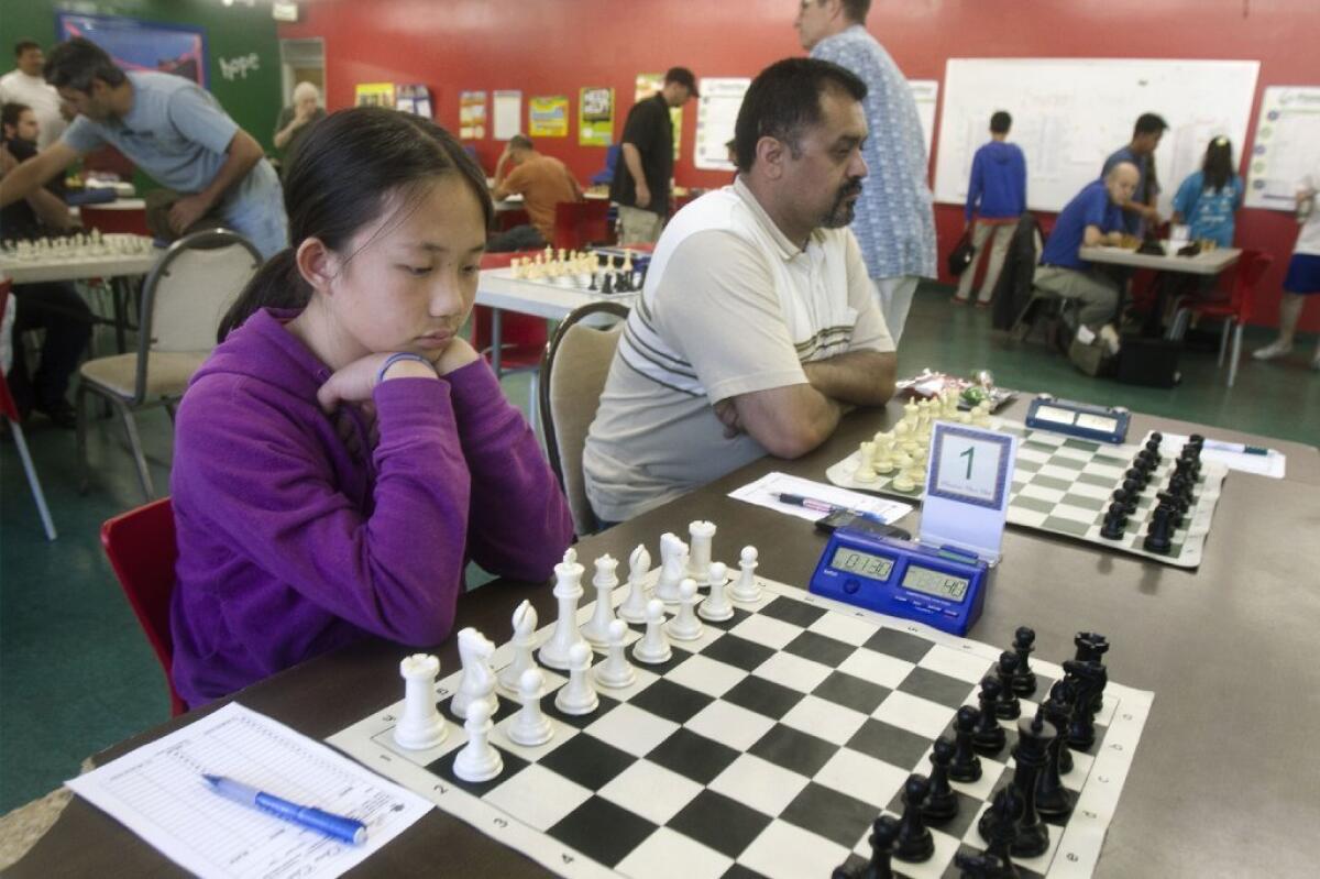 Annie Wang, who at 11 (at the time of the photo) is the country's youngest female chess master, gets ready to play at the Boys and Girls Club in Pasadena last month.