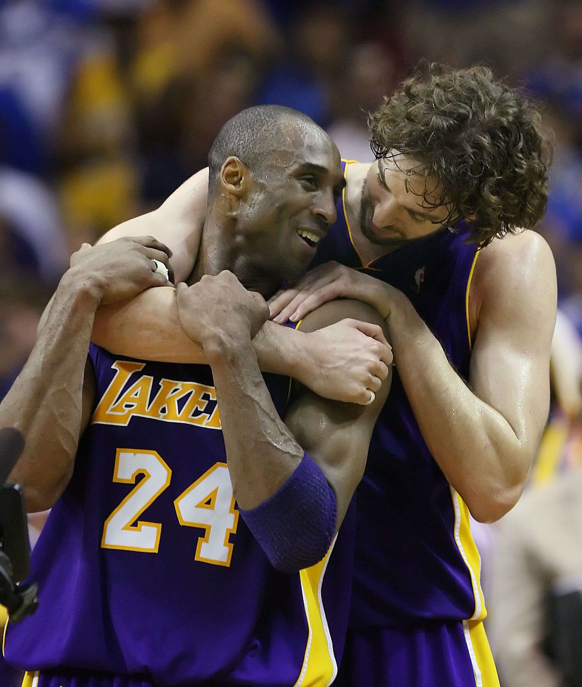 Pau Gasol and Kobe Bryant share a warm embrace at center court as they realize victory is imminent over the Magic.