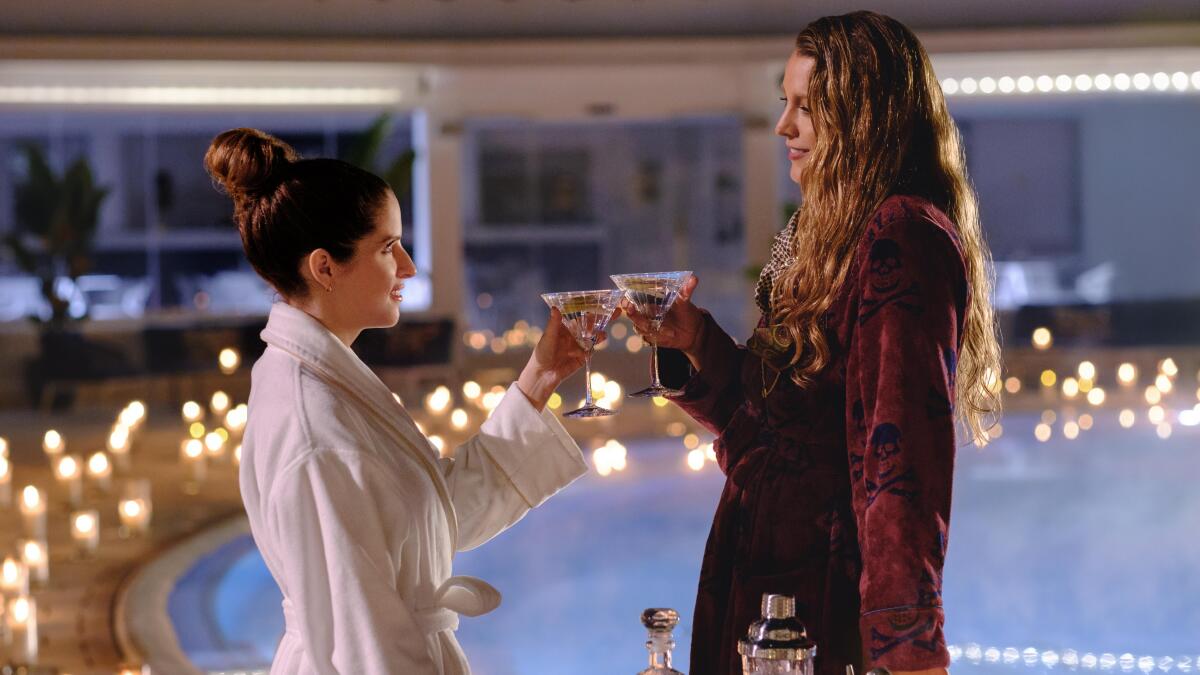 Anna Kendrick, left, and Blake Lively raise their cocktail glasses in the film "Another Simple Favor"