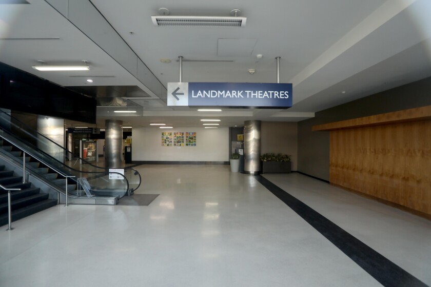 A sign says "Landmark Theatres" and points down a hall