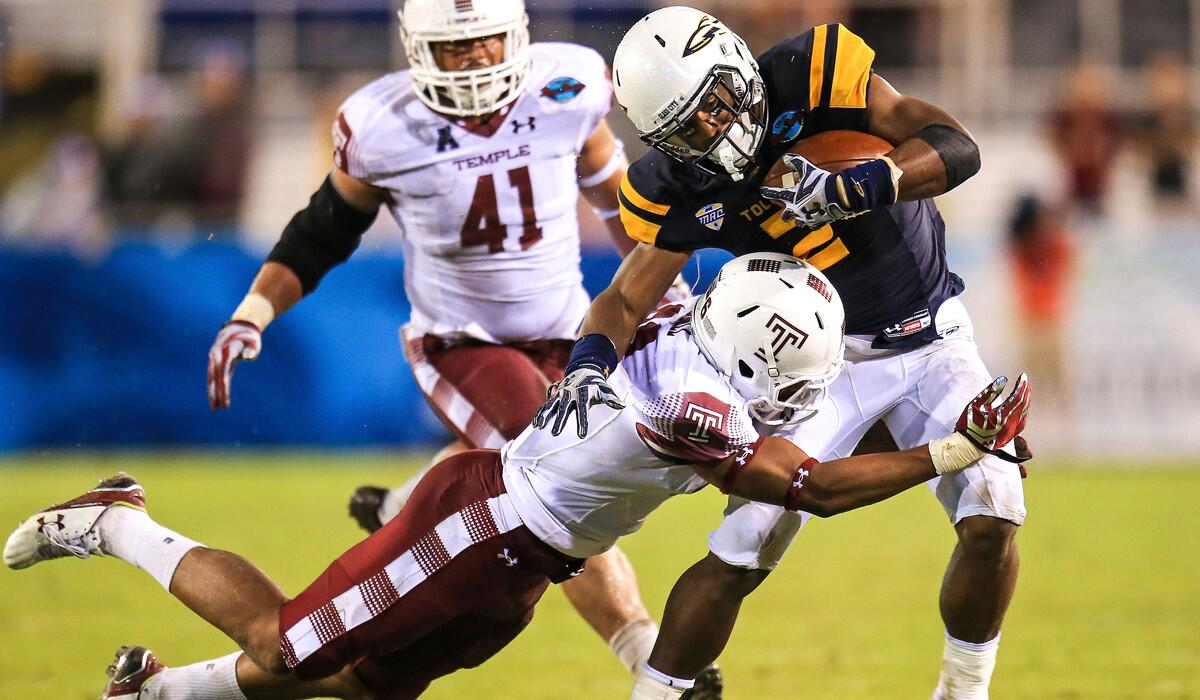 Toledo's Terry Swanson (2) is hit by Temple's Delvon Randall (26) during the second half on Tuesday.