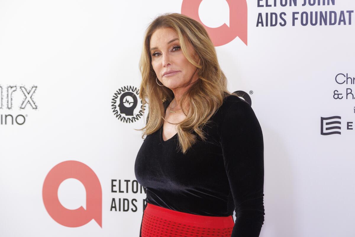 A blond woman wearing a black blouse and red skirt