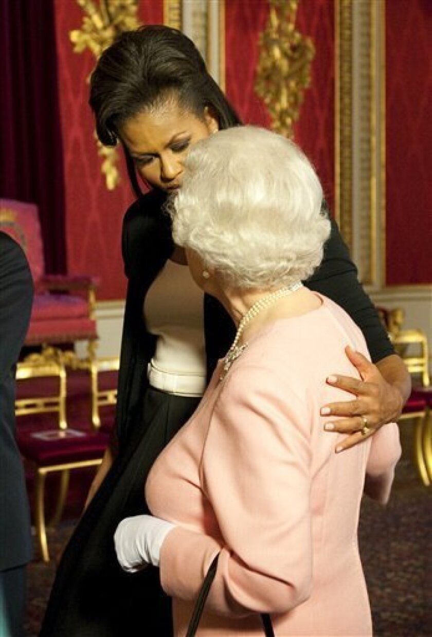 Michelle Obama, wife of U.S. President Barack Obama, left, walks with Britain's Queen Elizabeth II at the reception at Buckingham Palace in London Wednesday, April 1, 2009. (AP Photo/Daniel Hambury, pool)