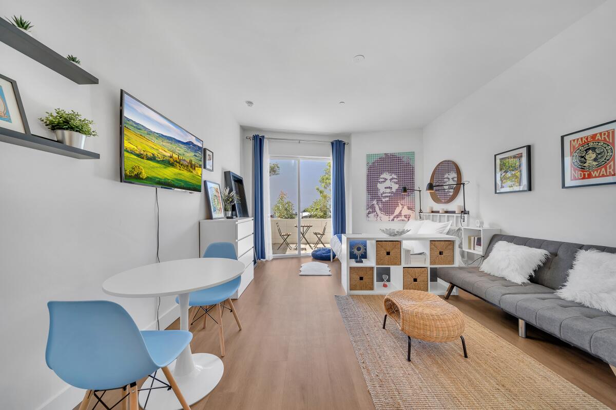 A view of a studio inside Cocoon 63 in Gardena shows a ground-floor unit with a sofa and dining area.