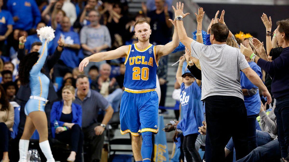 UCLA guard Bryce Alford high-fives the crowd after nailing a three-point basket against USC during the Bruins' 102-70 win at Pauley Pavilion on Feb. 18.