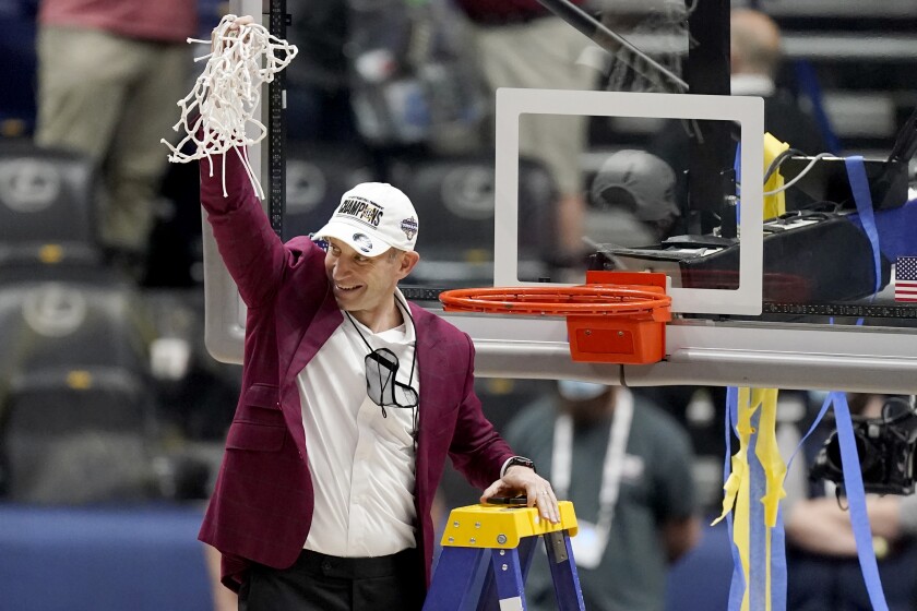 Alabama head coach Nate Oats waves to fans after cutting down the net after the championship game of the NCAA college basketball Southeastern Conference Tournament against LSU Sunday, March 14, 2021, in Nashville, Tenn. Alabama won 80-79. (AP Photo/Mark Humphrey)