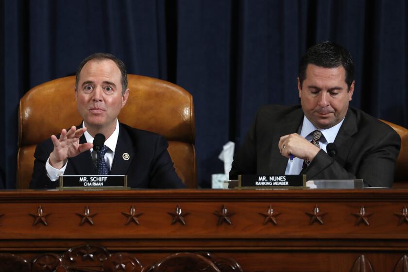 House Intelligence Committee Chairman Adam Schiff, D-Calif., left, and ranking member Rep. Devin Nunes of Calif., speak as Jennifer Williams, an aide to Vice President Mike Pence, and National Security Council aide Lt. Col. Alexander Vindman, testify before the House Intelligence Committee on Capitol Hill in Washington, Tuesday, Nov. 19, 2019, during a public impeachment hearing of President Donald Trump's efforts to tie U.S. aid for Ukraine to investigations of his political opponents. (AP Photo/Jacquelyn Martin, Pool)