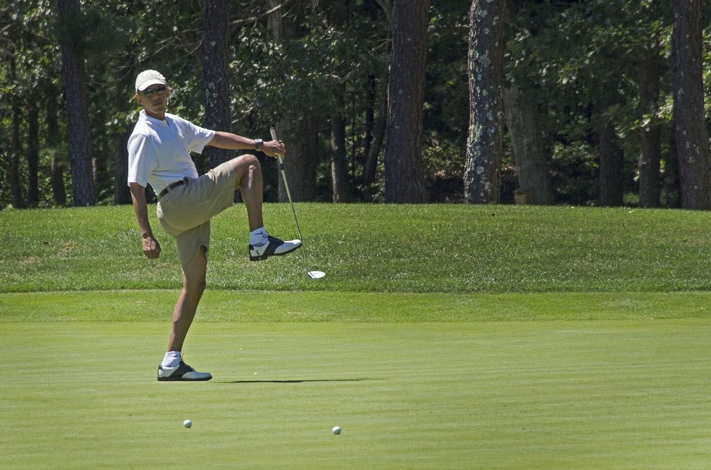 President Obama reacts to a missed putt on the first green at Farm Neck Golf Club in Oak Bluffs, Mass., during the Obama family vacation at Martha's Vineyard.