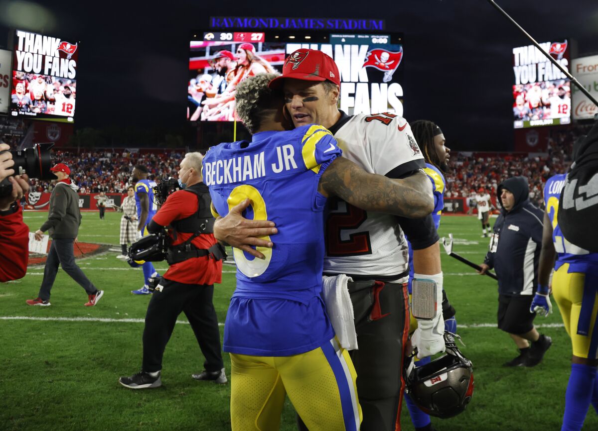 Tampa Bay Buccaneers quarterback Tom Brady hugs Rams receiver Odell Beckham Jr. 
