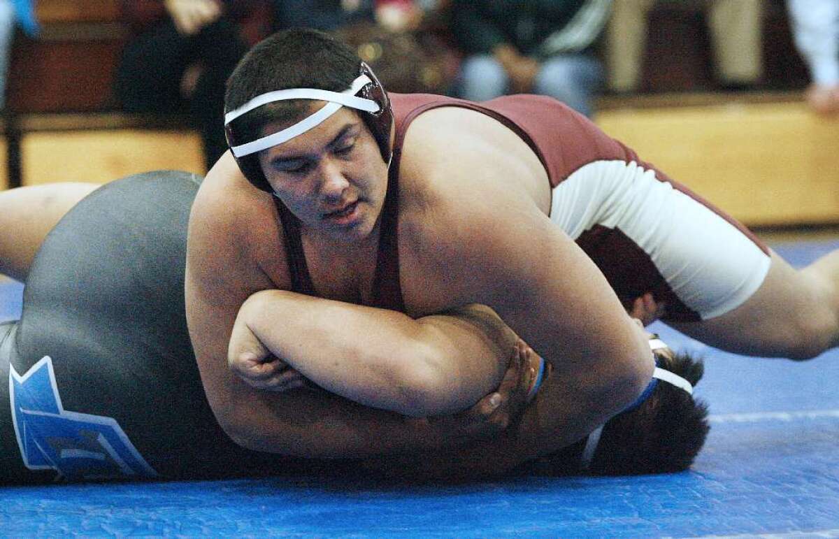 FILE PHOTO: La Cañada High wrestler Guillermo Padilla, top, who advanced to the CIF State Meet, will look to build on his accomplishments under new, yet familiar coach Justin Luthey in his senior season.