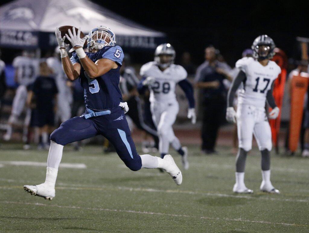 Corona del Mar's Cameron Kormos pulls in a pass for a touchdown against Trabuco Hills.