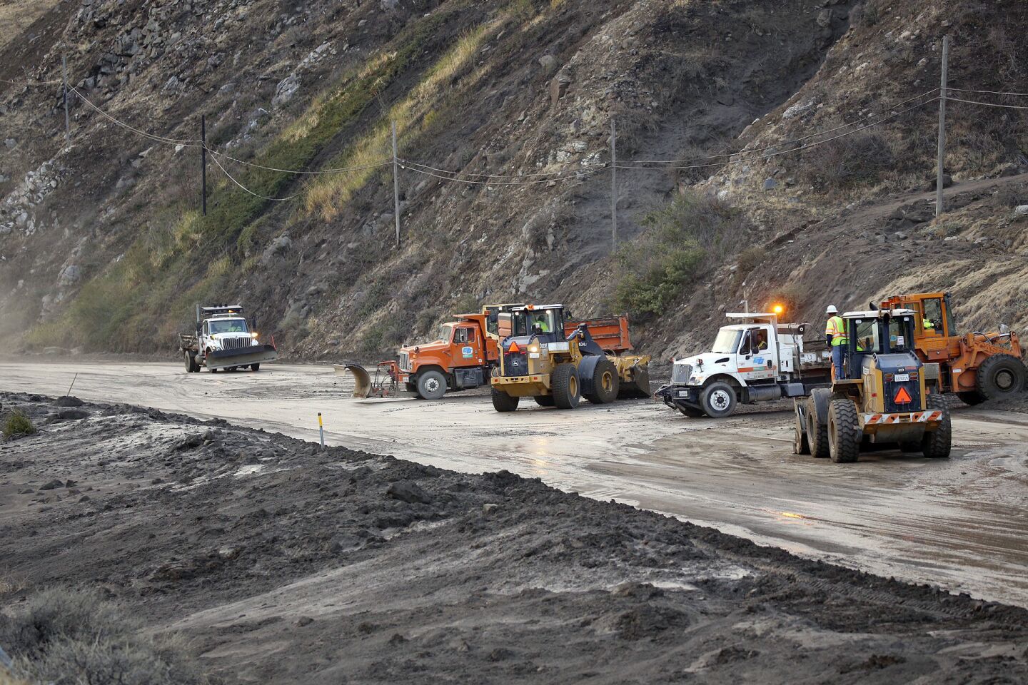 Caltrans crews work to clear mud, boulders and debris Friday morning from the southbound lanes of Interstate 5 in the Grapevine after a heavy rain on Thursday closed the highway.