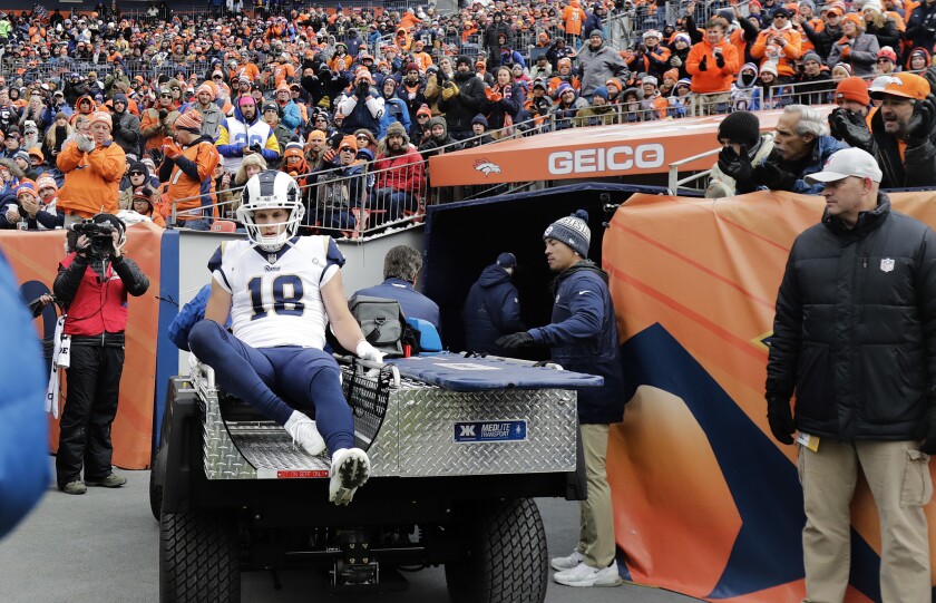 Rams wide receiver Cooper Kupp (18) leaves the game with a knee injury against the Denver Broncos at Broncos Stadium at Mile High on Sunday.
