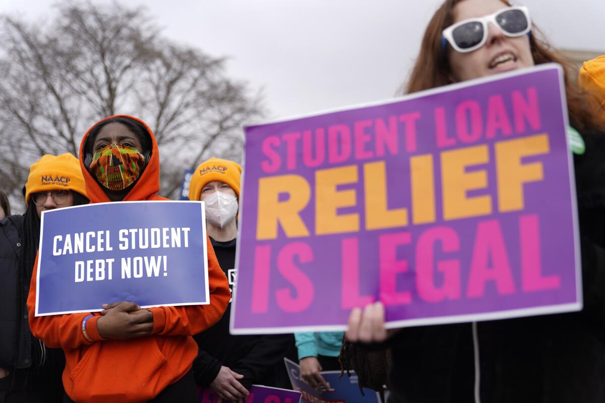 Student debt relief advocates hold signs outside the Supreme Court on Feb. 28, 2023