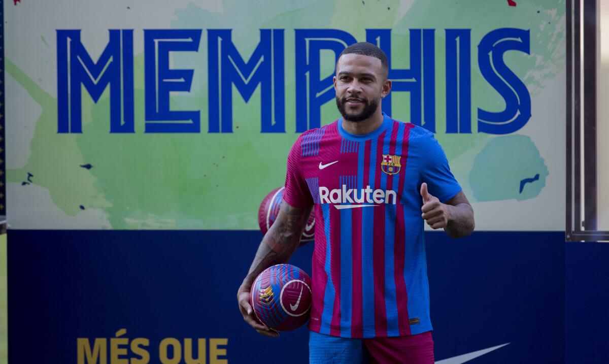 Netherlands striker Memphis Depay poses for the media during his official presentation after signing for FC Barcelona in Barcelona, Spain, Thursday July 22, 2021. Depay previously played for PSV Eindhoven, Manchester United and Lyon. (AP Photo/Joan Monfort)