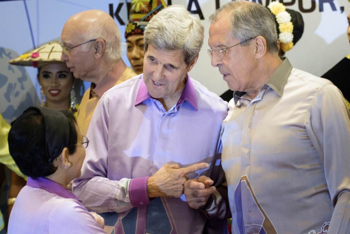 U.S. Secretary of State John F. Kerry, center, and Russian Foreign Minister Sergei Lavrov, right, chat with their Indonesian counterpart, Retno L.P. Marsudi, during Wednesday's meeting of the Assn. of Southeast Asian Nations.
