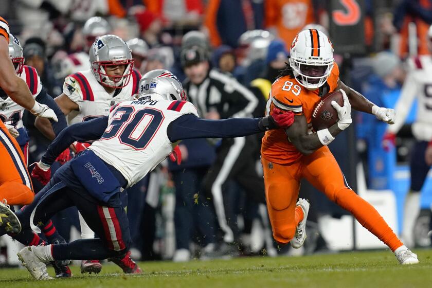 FILE -New England Patriots linebacker Marte Mapu (30) tries to tackle Denver Broncos wide receiver Brandon Johnson (89) in the second half of an NFL football game in Empower Field at Mile High Sunday, Dec. 24, 2023, in Denver. Playing for multiple schools no longer raises a red flag for NFL talent evaluators in this day and age of the ever busier transfer portal and increasingly eye-popping financial windfalls available to college football players before they're even old enough to buy a round of drinks. (AP Photo/Geneva Heffernan, File)