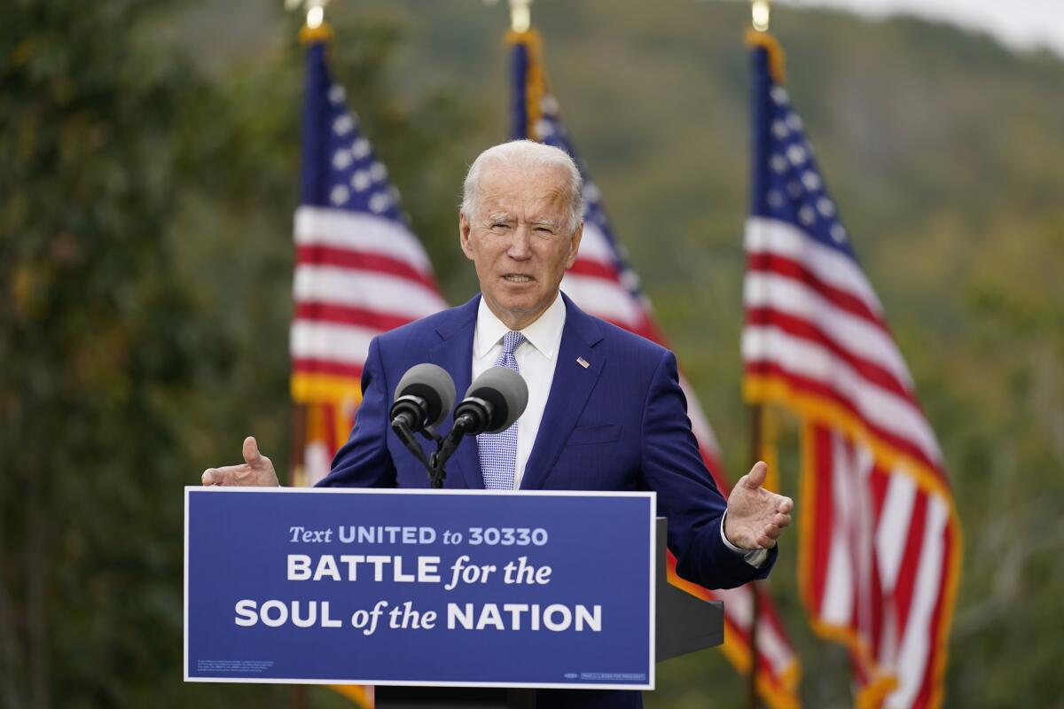 Joe Biden campaigns outside in Warm Springs, Ga., with a sign reading: "Battle for the soul of the nation."