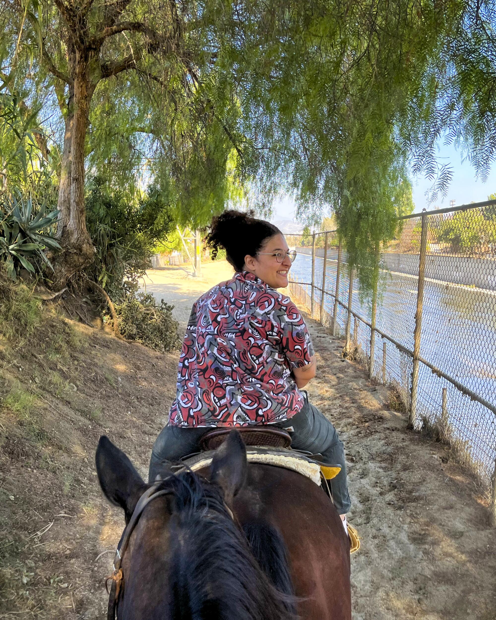 A person rides a horse with LA Horse Rentals.