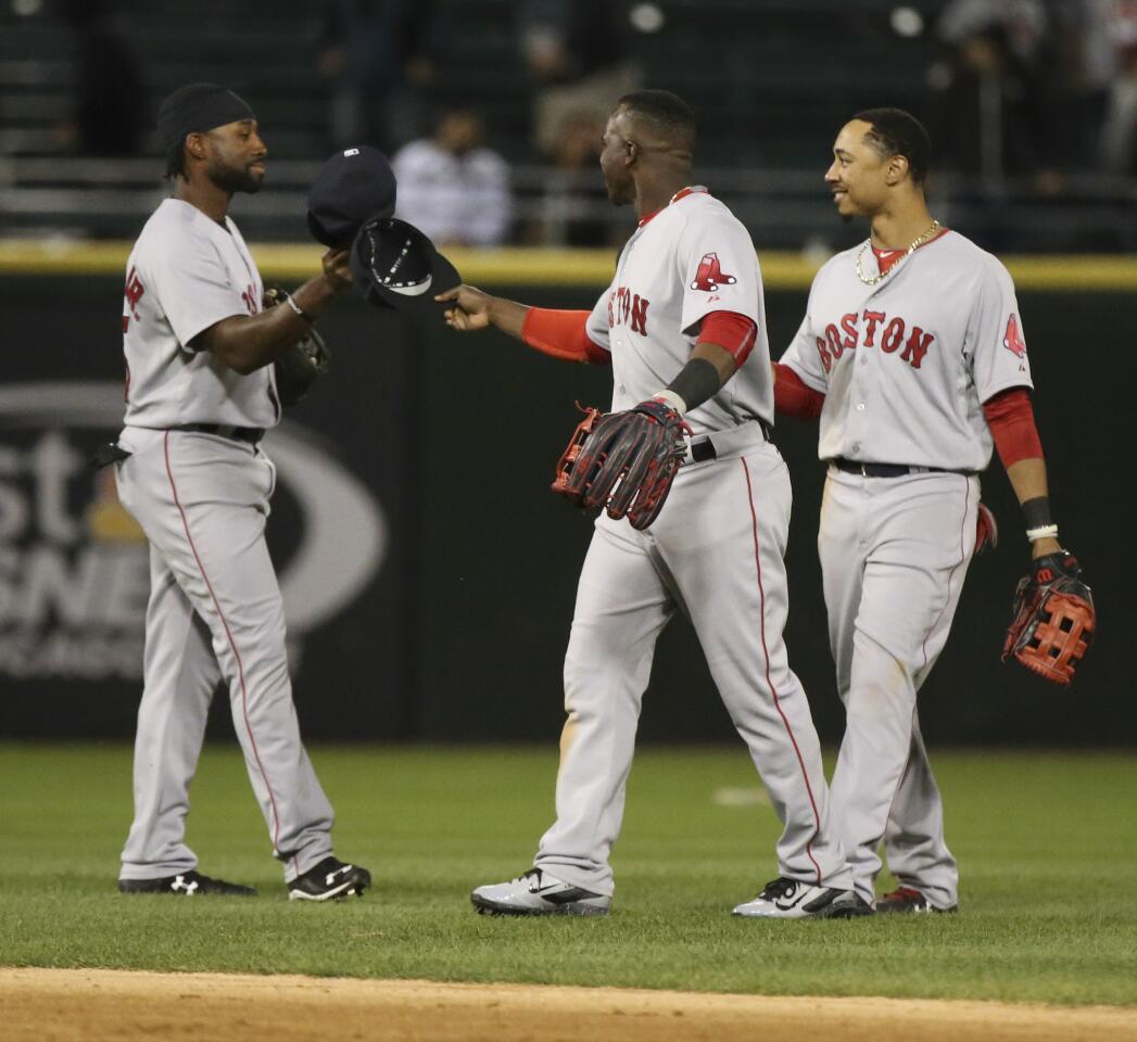 Left to right, Red Sox center fielder Jackie Bradley Jr., right fielder Rusney Castillo, and center fielder Mookie Betts at the end of their team's 5-4 win.