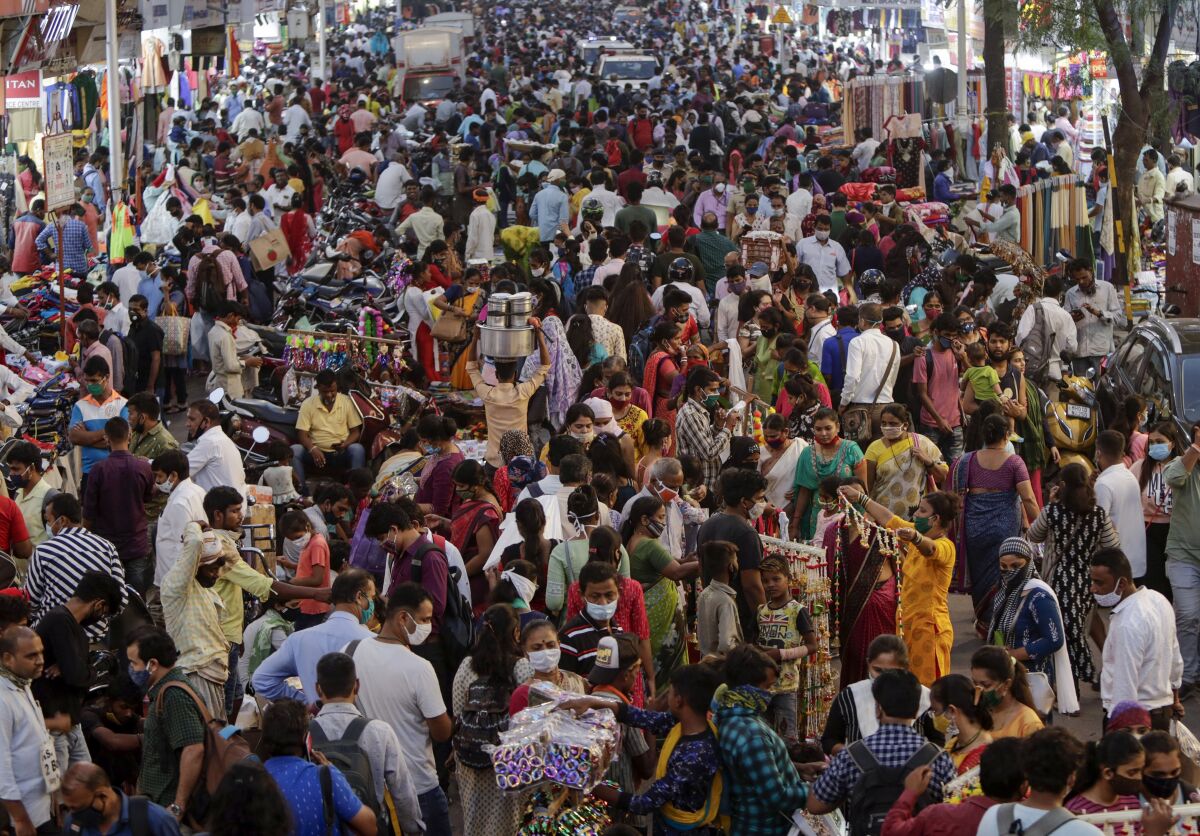 People crowd a market place for Diwali festival shopping in Mumbai, India