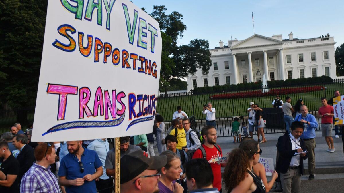 Protesters gather at White House after Trump's transgender announcement.