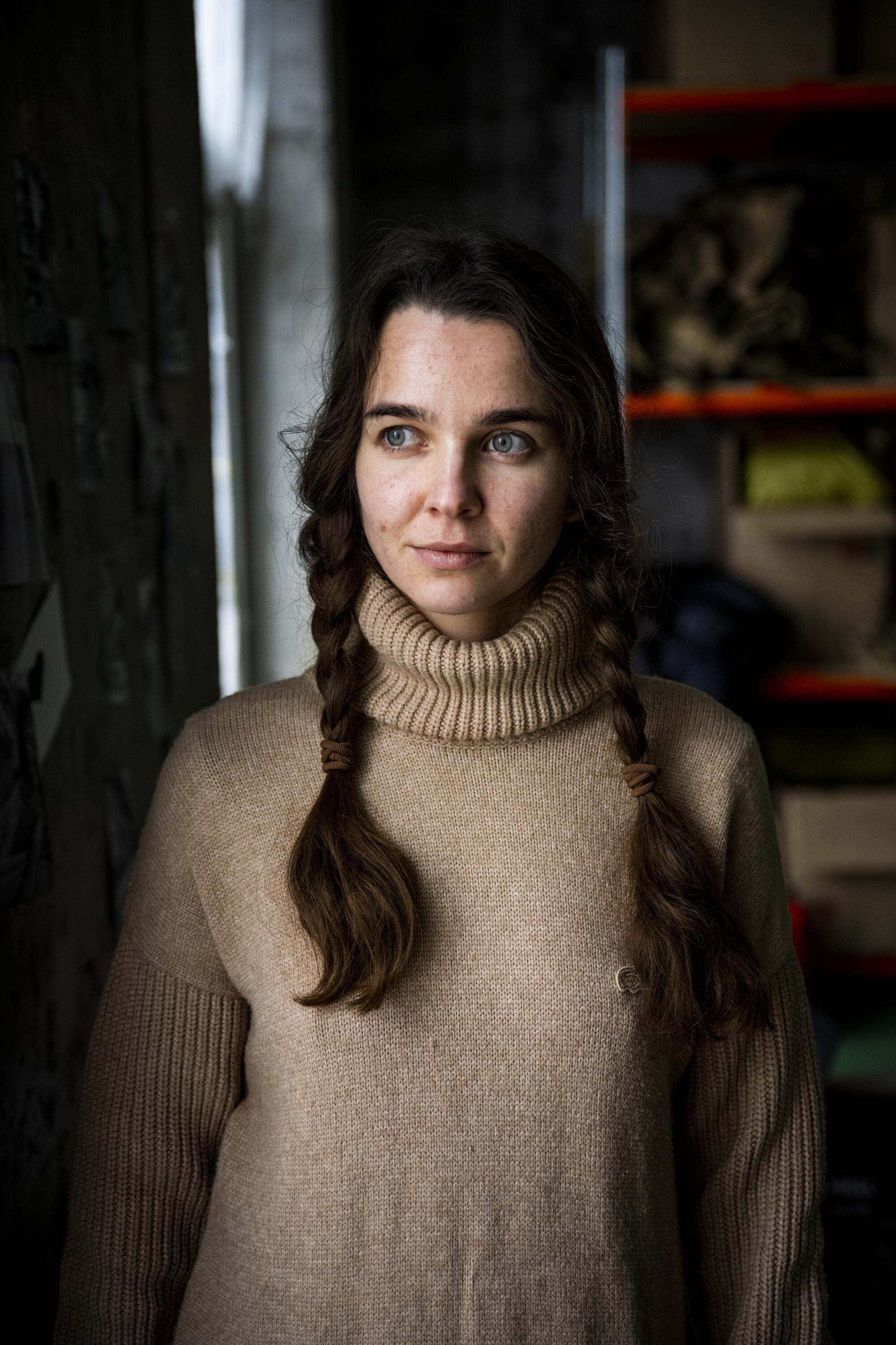 Portrait of a woman in her 20s, with a slight smile  