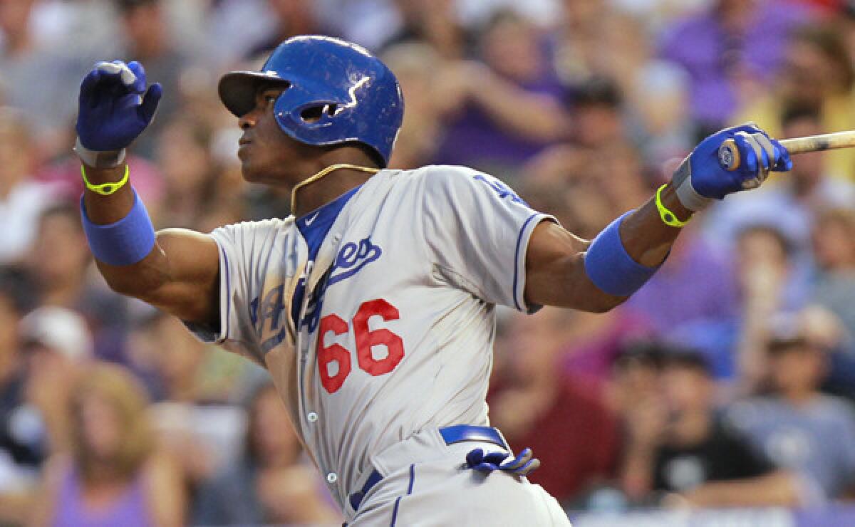 Dodgers outfielder Yasiel Puig hits a solo home run during the seventh inning of the Dodgers' 8-0 victory over the Colorado Rockies on Tuesday.